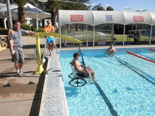 Men using a pool hoist